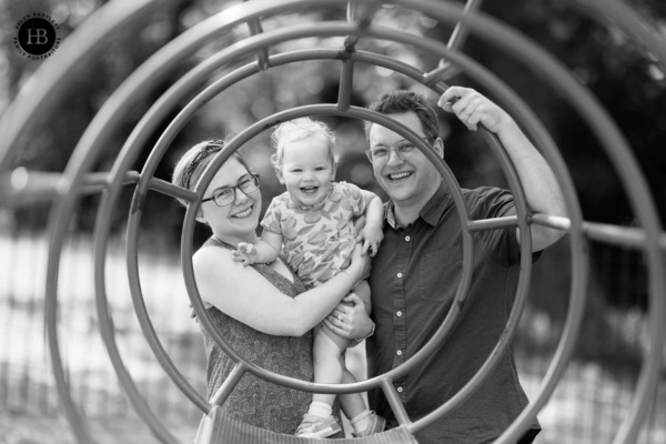 laughing-family-framed-by-climbing-frame