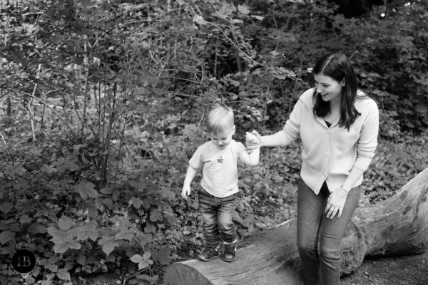 little-boy-walks-on-log-with-mother