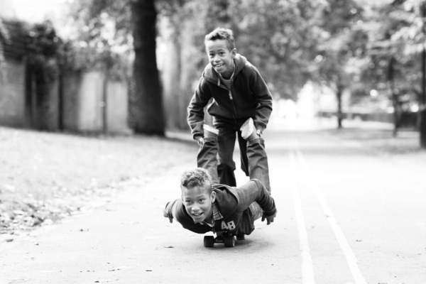 This black and white portrait shows a family playing in Holland Park W11.