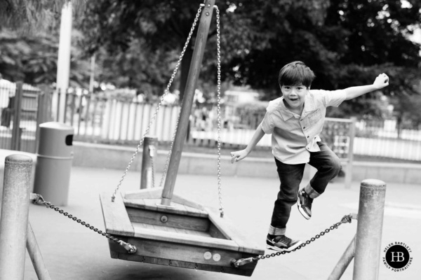 boy-balances-on-play-equipment