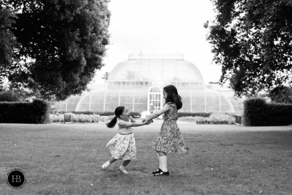 children-play-in-front-of-glasshouse-kew-gardens