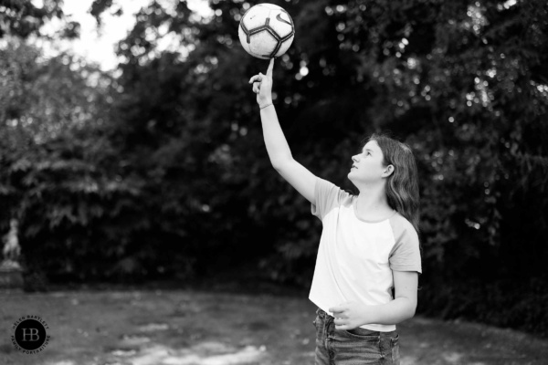 girl-spins-football-on-finger