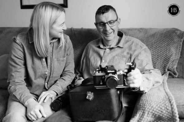 man-and-lady-look-at-old-nikon-camera