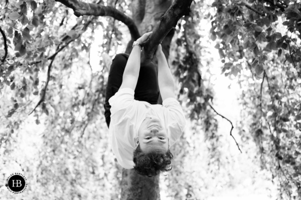 teenage-boy-playing-in-tree-portrait