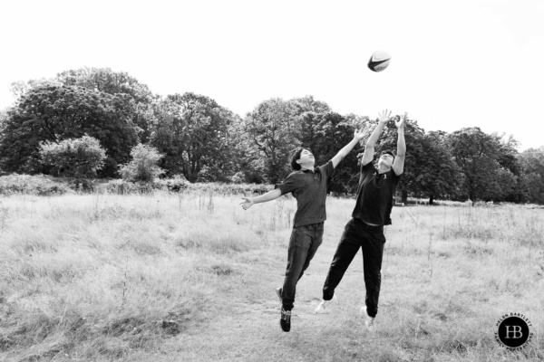 teenage-boys-jump-to-catch-rugby-ball