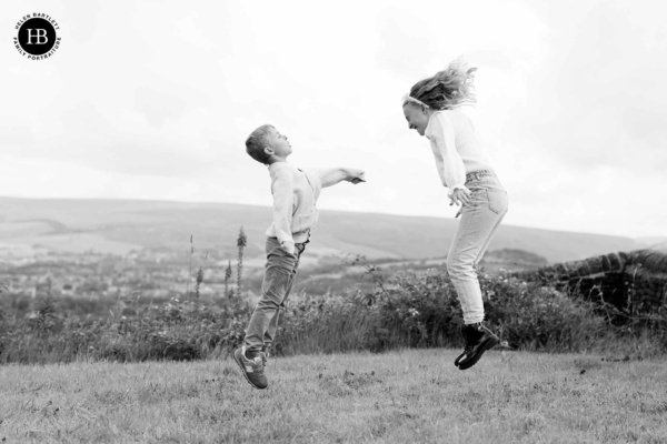 two-children-jumping-in-air-countryside-photo-shoot