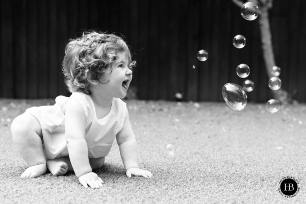 baby-looks-at-bubbles-in-garden