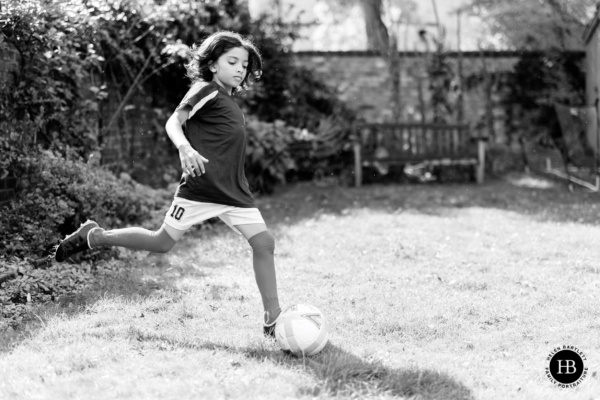 boy-plays-football-in-garden