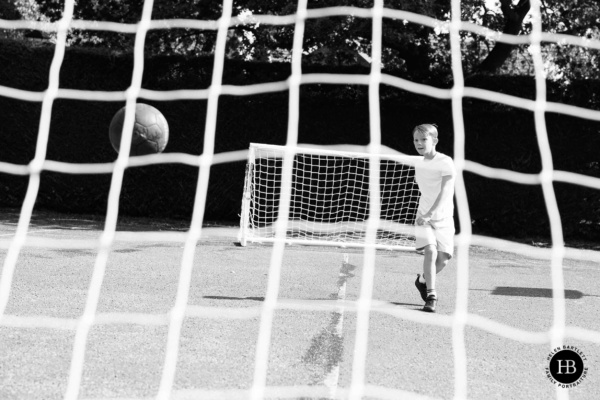 child-playing-football-on-family-photo-shoot