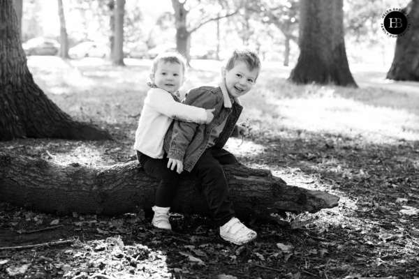 laughing-children-sitting-on-log