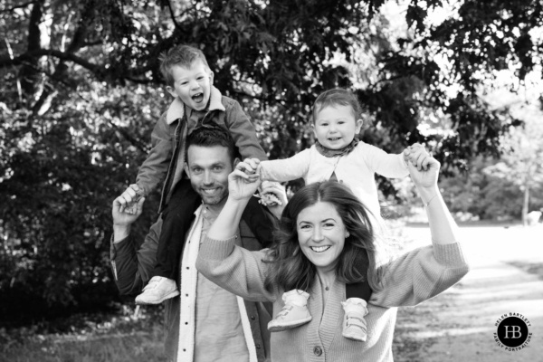 laughing-family-photo-clapham-with-toddler-on-parents-shoulders