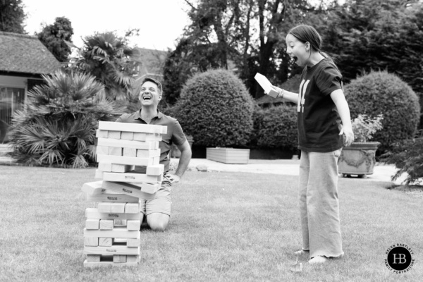 laughing-portrait-father-daughter-play-jenga