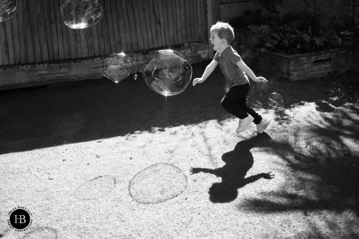 little-boy-chases-bubbles-wiht-shadows