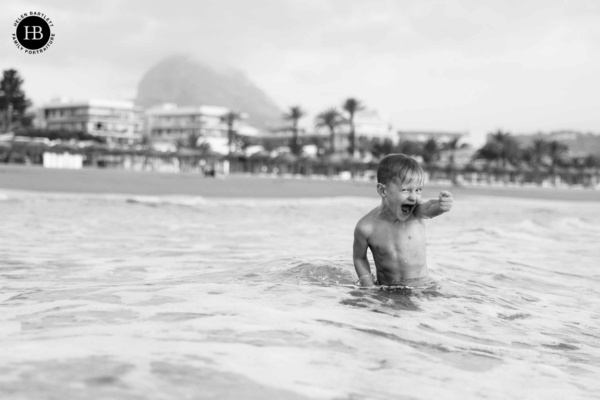 little-boy-laughing-in-sea-spain