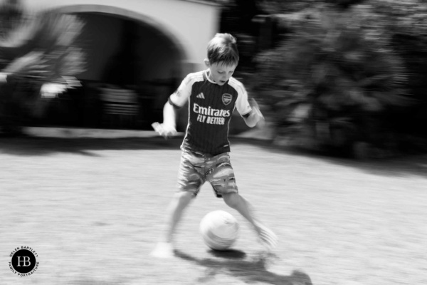 panning-shot-boy-playing-football