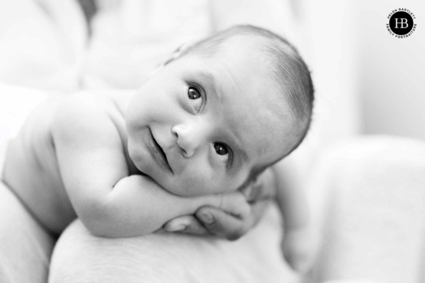 smiling-newborn-baby-held-in-hand