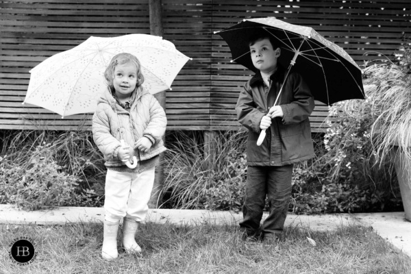 children-shelter-under-umbrellas