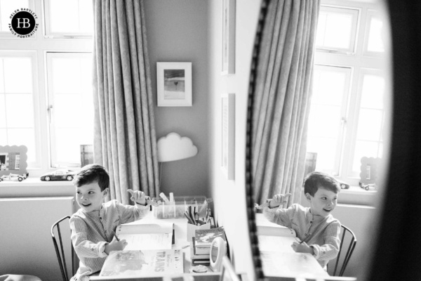 little-boy-does-homework-reflected-in-mirror