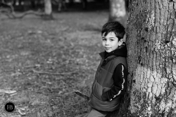 portrait-of-boy-leaning-against-tree