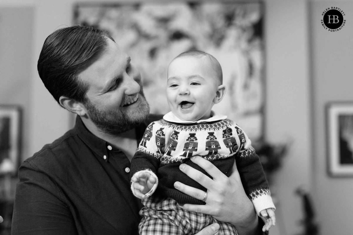 father-holds-laughing-baby-family-photo-shoot