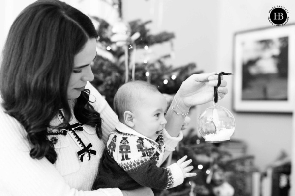 mother-shows-baby-snowglobe-christmas-decoration