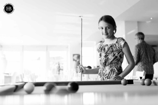 teenager-plays-pool-on-family-photo-session