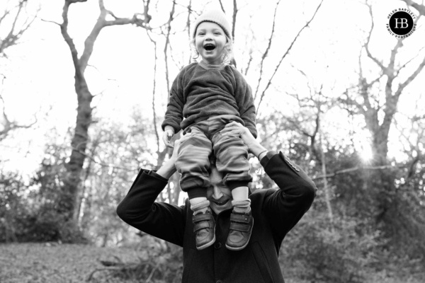 little-boy-laughs-while-being-held-on-fathers-head