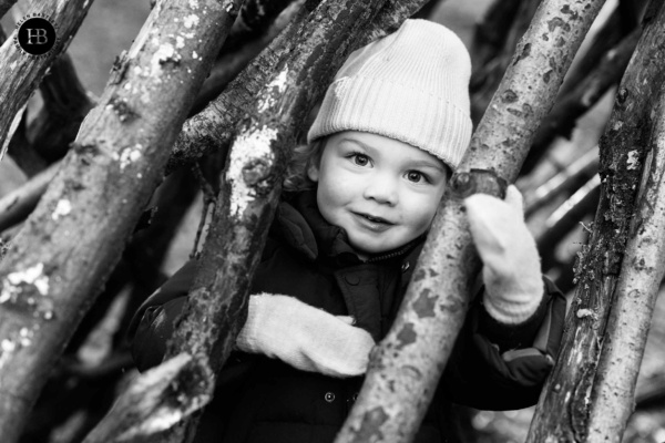 little-boy-wearing-mittens-plays-in-woodland-den