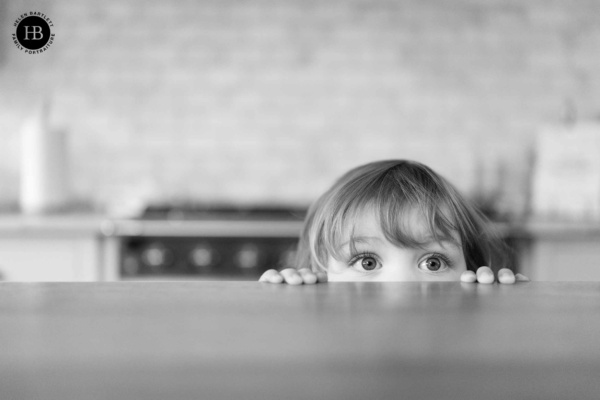 toddler-peeks-over-the-top-of-the-counter