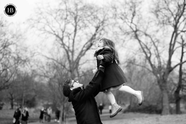 father-throws-laughing-child-in-air-clapham