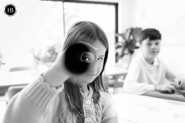 child-looks-through-cardboard-tube-on-photo-shoot-clapham-sw4