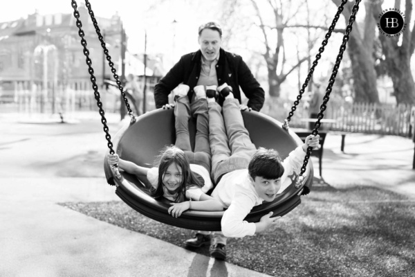 children-play-on-swing-clapham-common-playground