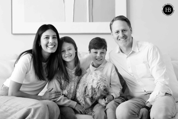 family-and-dog-sit-on-sofa
