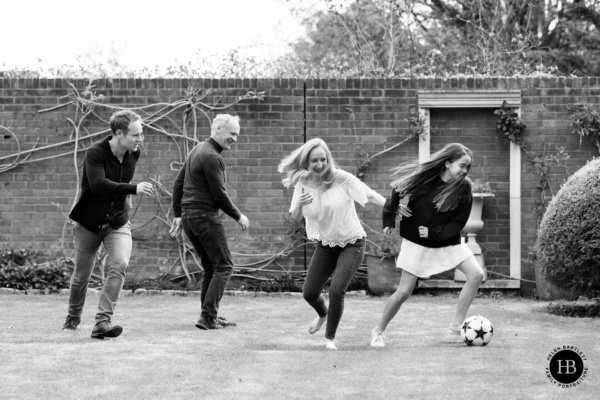 family-plays-football-in-garden