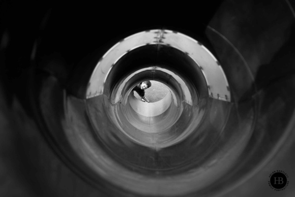 little-boy-looks-up-through-slide-highgate-woods