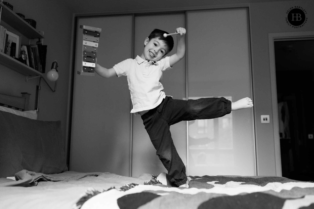 little-boy-play-xylophone-while-jumping-on-bed