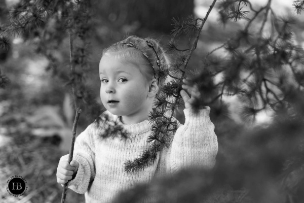 little-girl-looks-through-tree-branches