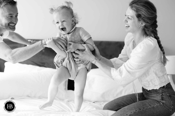 family-play-on-bed-joyful-family-photo-shoot