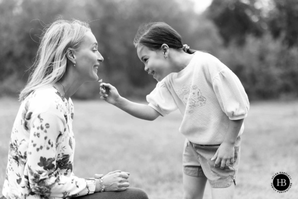 girl-checks-if-mother-likes-butter-buttercup-taken-by-wimbledon-family-photographer-helen-bartlett