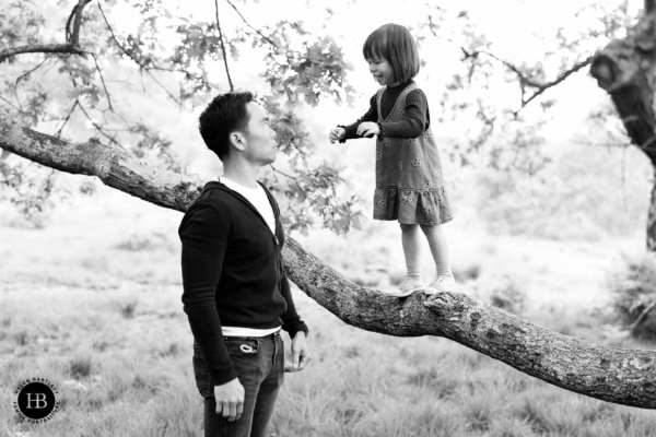 little-girl-balances-on-tree-branch