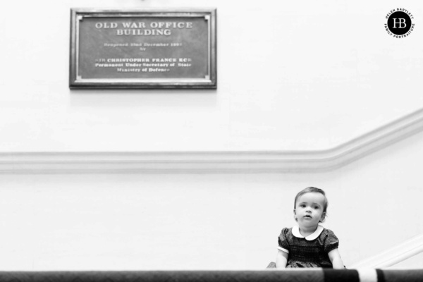 little-girl-sits-on-stairs-old-war-office-building-london