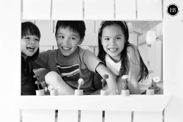 three-children-play-in-wooden-house