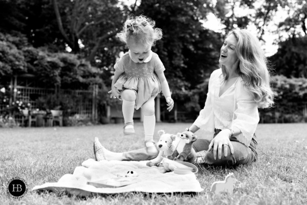toddler-jumps-for-joy-on-picnic-mat