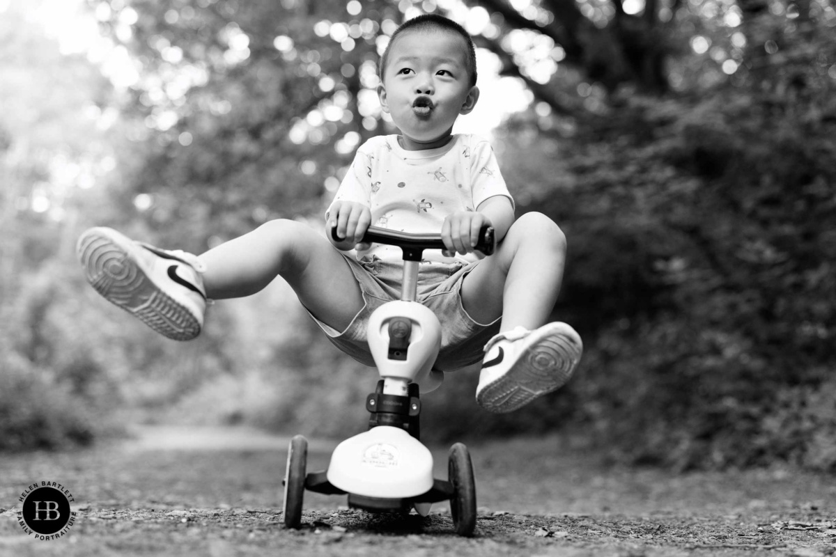 little-boy-rides-scooter-feet-in-the-air