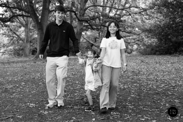 Three siblings walking hand in hand