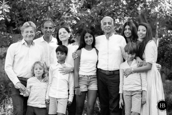 Large extended family group standing together outdoors and smiling during family photo shoot in Wimbledon