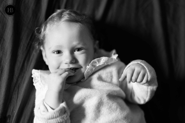 Baby lying back while playing with their fingers