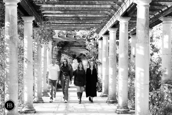 Family walking together through the Pergola at Hampstead Heath during a family photography session with teenagers
