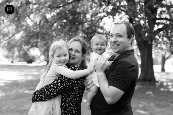 Family of four in eyes-to-camera group shot