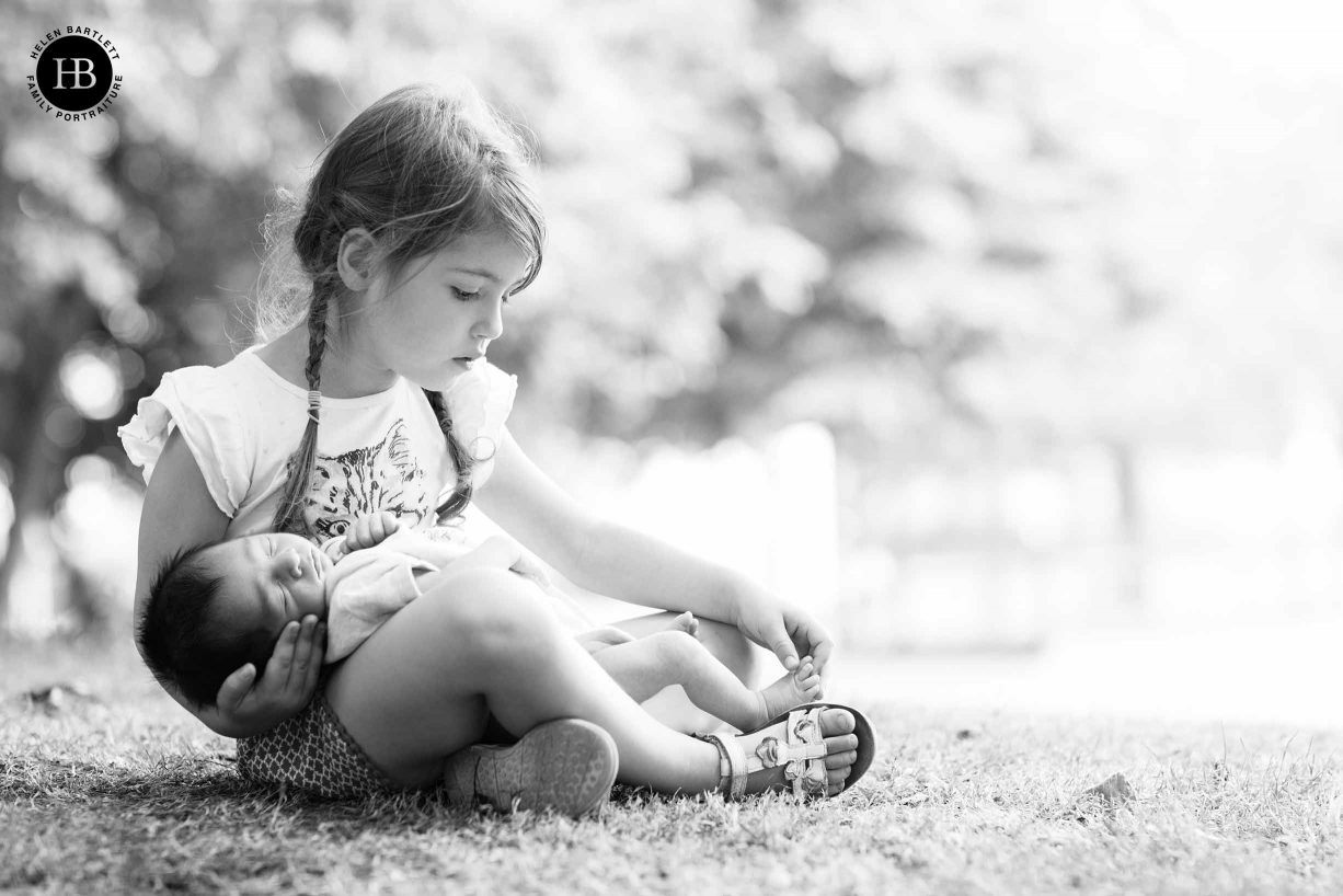 professional photo of little girl holding newborn sibling in greenwich south London